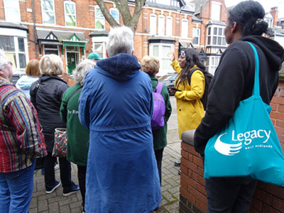 photo of a group looking at the architecture of houses in a Handsworth street.